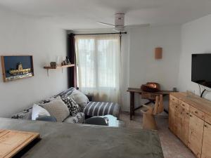 a living room with a couch and a tv at Atlas Apartments Ibiza in Santa Eularia des Riu