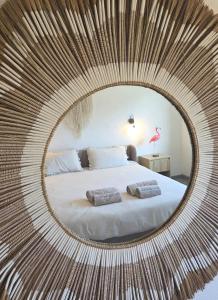 a circular mirror with a bed in a room at Casa Lumina in Lachapelle-sous-Rougemont