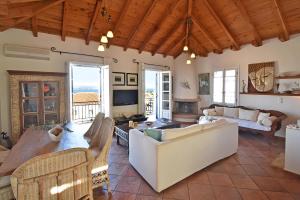 a living room with couches and a table at Casa di Spetses in Spetses