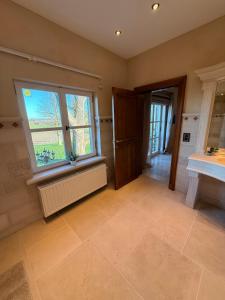 a large bathroom with a sink and a window at Château D - Roncheval in Mouscron