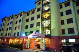 a large building with a store in front of it at Seasons Airport Hotel Nairobi in Nairobi
