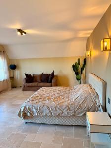 a bedroom with a bed and a couch at Château D - Roncheval in Mouscron