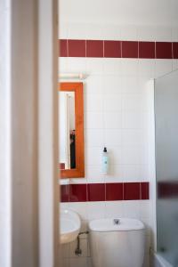 a bathroom with a toilet and a sink and a mirror at Sant Joan Apartaments - Adults Only in Cala en Blanes +33 photos
