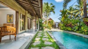 an exterior view of a house with a swimming pool at Diva Villa Sanggingan Ubud in Ubud