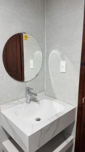 a bathroom with a white sink and a mirror at Han House's Apartment in Danang +15 photos