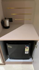 a shelf in a kitchen with a counter top at Us Group Stays Omaxe Hazratganj in Nalmatha