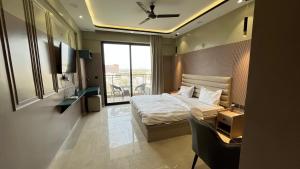 a hotel room with a bed and a window at Us Group Stays Omaxe Hazratganj in Nalmatha