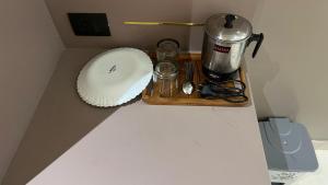 a counter with a coffee maker and a blender at Us Group Stays Omaxe Hazratganj in Nalmatha +1 photo