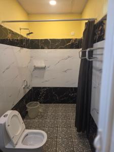 a bathroom with a toilet and a sink in it at SPKA Jungle Resort in Vālpārai +22 photos