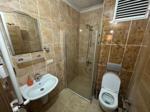 a bathroom with a shower and a toilet and a sink at Borahan Hotel in Trabzon +28 photos