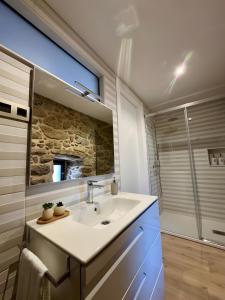 a bathroom with a sink and a mirror and a shower at Mar Do Val in Muxia +37 photos