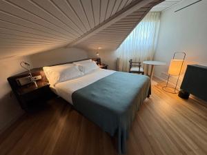 a bedroom with a bed and a table in a room at Hotel Terradets in Cellers +43 photos