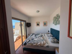 a bedroom with a bed and a view of the ocean at Fully equipped seaview Cabezo flat in El Médano