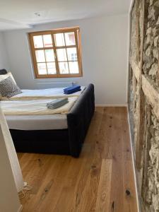 a bedroom with a bed in a room with a window at Zentrales Schloss Apartment in Arbon