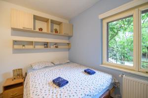 a bedroom with a bed with two blue bags on it at Nostromo in Kotor