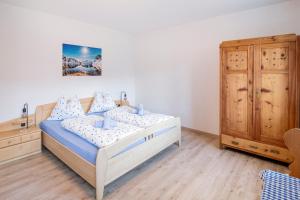 a bedroom with a bed and a wooden cabinet at Rieplhof - Relaxing farm stay with breakfast and mountain view in Vipiteno +29 photos