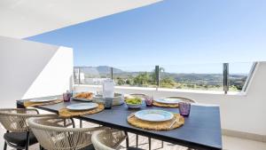 a black table with plates of food on it at Oasys de Ipanema in La Cala de Mijas