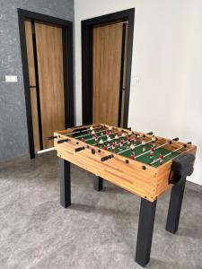 a wooden foosball table with avertisement for at Biebrzańska Dolina 2 in Goniadz