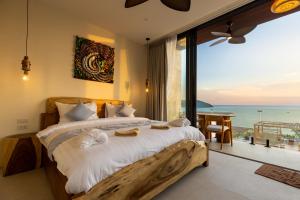 a bedroom with a bed with a view of the ocean at Villa Gaia in Ko Phangan +61 photos