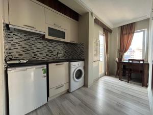 a kitchen with a washer and dryer in a room at Borahan Hotel in Trabzon