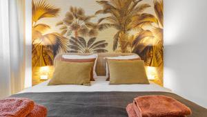 a bedroom with a large bed with a tropical wallpaper at Oasys de Ipanema in La Cala de Mijas