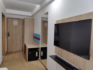 a large flat screen tv hanging on a wall at FlxHo Corporate Stays - Udyog Vihar in Gurgaon