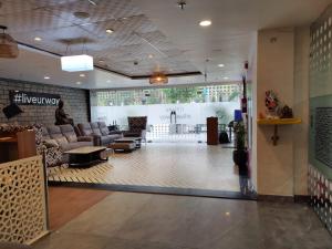 a lobby of a store with couches and a waiting room at FlxHo Corporate Stays - Udyog Vihar in Gurgaon