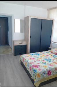a bedroom with a bed and a dresser and a bed sidx sidx sidx sidx at Shaterovi Gerbera Panoram in Plovdiv