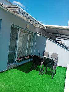 a patio with a table and chairs on a house at Shaterovi Gerbera Panoram in Plovdiv
