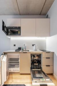 a kitchen with an open dishwasher in the middle at Noli Gdansk Old Town in Gdańsk