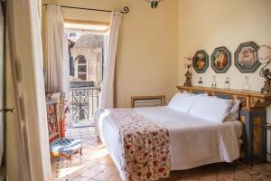 a bedroom with a bed and a balcony at Palazzo Nobili in Capri