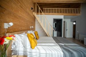 a bedroom with a large white bed with yellow pillows at Beeography guest house in Vardablur +43 photos