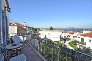 a balcony with chairs and a table on a building at Casa di Spetses in Spetses
