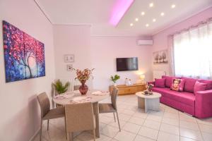 a living room with a purple couch and a table at Aelia Luxury Suites Melissi in Xylokastro