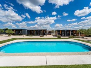 a large blue swimming pool in front of a house at Adria Mobile Home in Pirovac