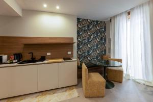 a kitchen with a counter and a table and a chair at Rial Collection Luxury Suite in Syracuse +22 photos