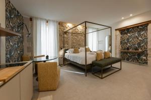 a bedroom with a bed with a mirror and a table at Rial Collection Luxury Suite in Syracuse