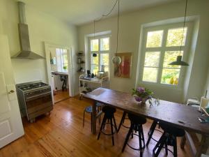 a large kitchen with a wooden table and chairs at The Old Parsonage in Søndersø