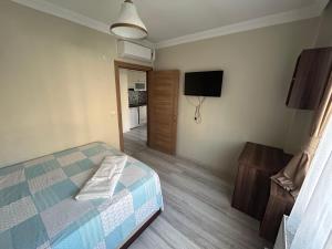 a bedroom with a bed and a flat screen tv at Borahan Hotel in Trabzon