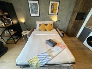 a bedroom with a large bed with two ties on it at Le Chaplin face au lac Léman in Évian-les-Bains