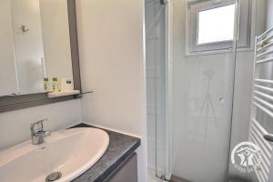 a bathroom with a sink and a shower at TI WAR AN DOUR in Guégon