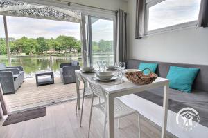 a dining room with a table and a view of the water at TI WAR AN DOUR in Guégon
