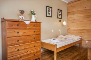 a small bedroom with a bed and a dresser at Pensjonat Iskra in Sztum +79 photos