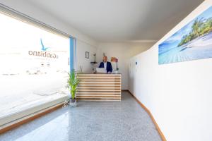 an office with a view of the beach through a window at Il Gabbiano rooms in Donnalucata