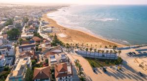 an aerial view of a beach and buildings at Il Gabbiano rooms in Donnalucata +36 photos
