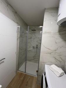 a bathroom with a shower with a glass door at Ana in Posušje