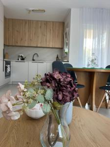 a vase of flowers on a table in a kitchen at Ana in Posušje