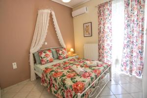 a bedroom with a bed with a canopy at Aelia Luxury Suites Melissi in Xylokastro