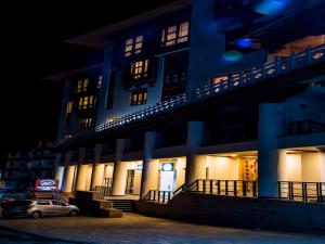 a blue building with a car parked in front of it at CityHotel, Thimphu in Thimphu