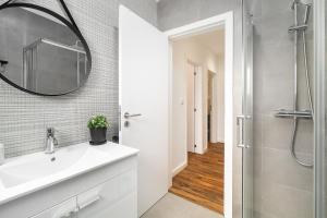 a bathroom with a sink and a shower at Garden Apartment with BBQ & Orange Tree - Near Lisbon & Sintra in Queluz